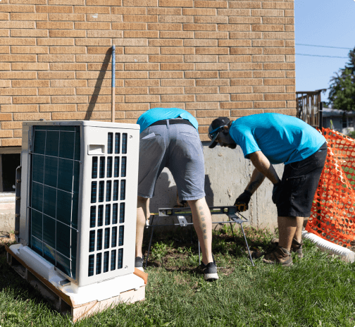 Placing an outdoor unit during a furnace installation.